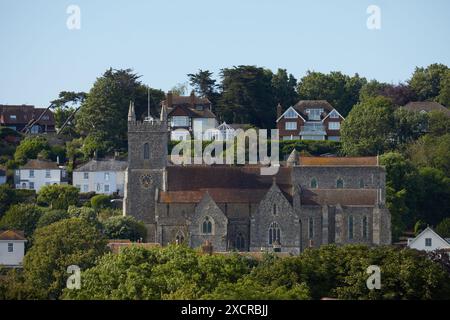 The 11th Century Church of Saint Leonard's, Hythe, Kent, UK. Showing part of Hythe town and the hill rising behind the church. Stock Photo