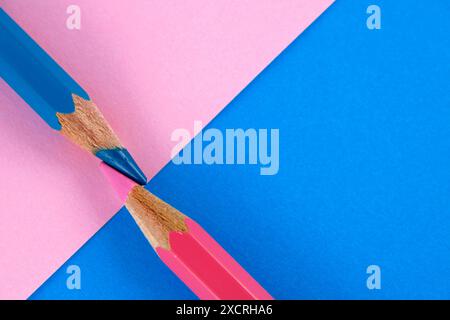 Blue and pink pencil on a background of the opposite color Stock Photo