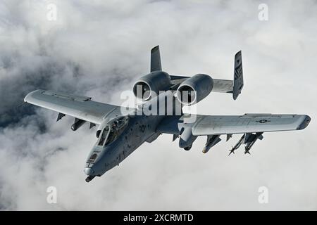 A U.S. Air Force A-10 Thunderbolt II assigned to the 25th Fighter Squadron finishes refueling from a KC-135 Stratotanker assigned to the 101st Air Ref Stock Photo