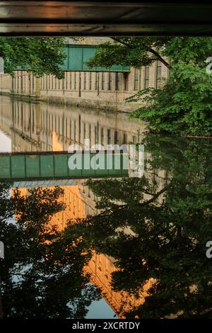 Salts Mill, a Victorian textile mill developed by Titus Salt on the river Aire in Saltaire, Shipley, Bradford, Yorkshire in the evening Sun Stock Photo