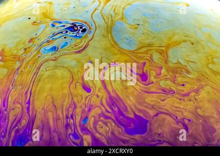 Close up macro, detailed shot of a soap bubble in professional, studio setting with black background behind. Stunning rainbow, colors abstract desktop Stock Photo