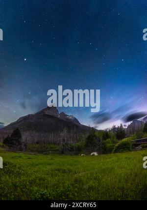 A vertical panorama of the moonlit spring sky with the Big Dipper and Arcturus over the jagged outline of Anderson Peak at the Red Rock Canyon area of Stock Photo