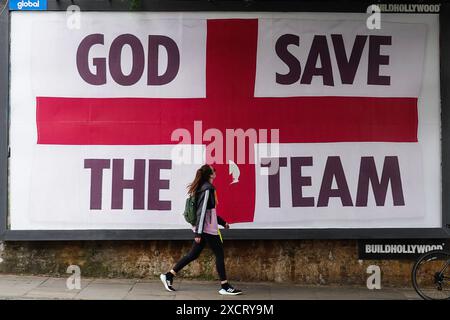 London, UK. 18th June, 2024. GOD SAVE THE TEAM billboards are artist Corbin Shaw's takes on Euro 2024 (in this case in Kentish Town). Corbin's work aims to challenge and reflect on what England represents today in this collaboration with BUILDHOLLYWOOD. Credit: Guy Bell/Alamy Live News Stock Photo