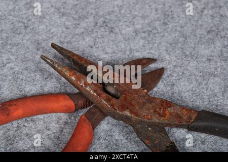 Rusty neglected hand tools, pliers, screwdriver and a hammer! Stock Photo