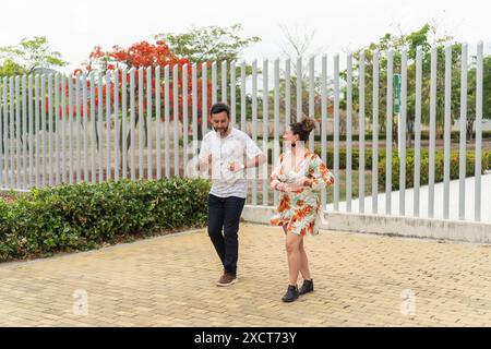 Joyful Couple Dancing Outdoors in Urban Park Stock Photo