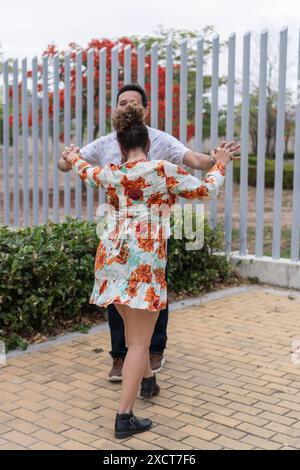 Couple dancing together outdoors in an urban setting Stock Photo