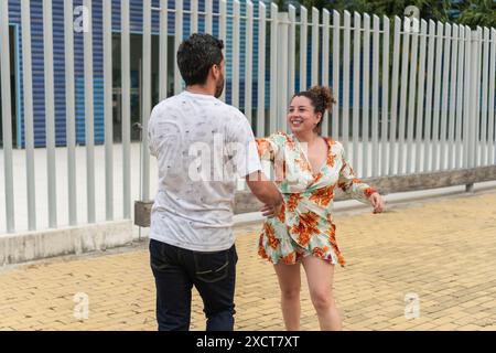 Joyful Couple Dancing Outdoors in Urban Area Stock Photo