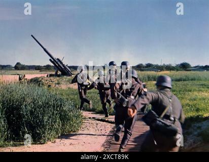 A photograph shows German soldiers at an anti-aircraft artillery (Flak) battery responding to an alarm during the Second World War. These heavy batteries were critical for defending against enemy aircraft, providing essential protection for strategic locations. The readiness and vigilance of the Flak crews were vital in maintaining air defense and supporting ground operations against aerial attacks. Stock Photo