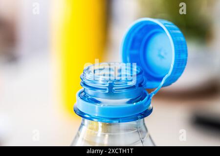 A detailed close-up of a blue tethered cap, attached to a clear plastic bottle, exemplifying environmental conservation efforts according to the EU Stock Photo