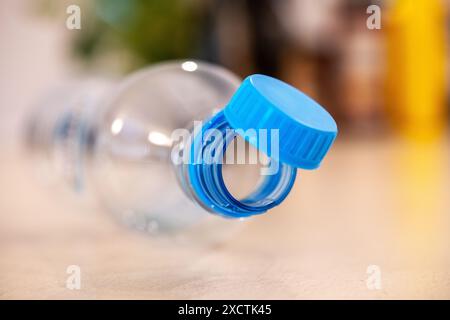 Close-up view of a plastic water bottle featuring a newly mandatory tethered blue cap, illustrating the upcoming EU regulations taking effect summer Stock Photo