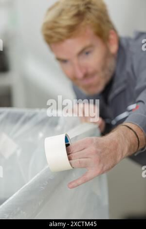 painter using a masking tape Stock Photo