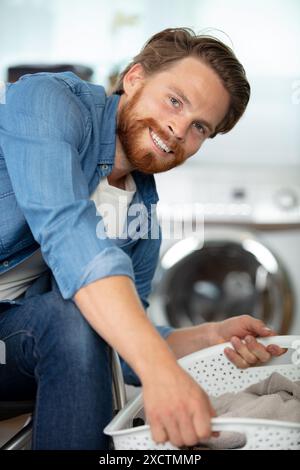 disabled man on wheelchair doing laundry Stock Photo