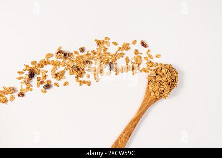 Granola with mixed nuts and died fruits in a wooden spoon, top view Stock Photo