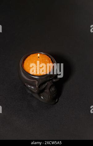 Skull candle isolated on black, spooky Halloween decor Stock Photo
