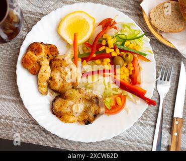 Oven baked hake with vegetable garnish Stock Photo