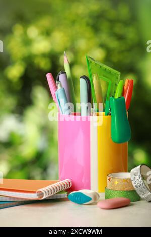 Stapler, notebooks, holder and other different stationery on white table Stock Photo