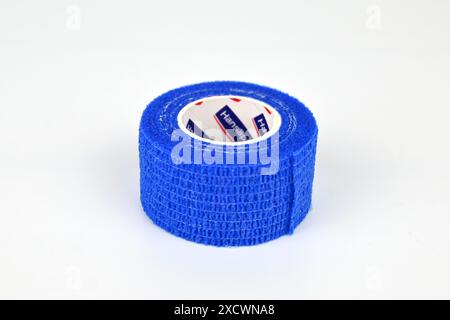 Blue self adhesive medical tape bandage  – Wales, UK  – 15 June 2024 Stock Photo