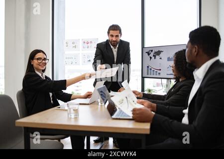 Business team discussing charts and graphs during meeting Stock Photo