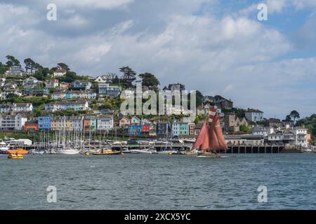 A gaff rigged yacht sailing up the River Dart going past Kingswear, opposite Dartmouth Stock Photo