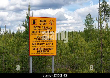 Military area keep out sign in Finnish, Swedish, Russian, English and German texts, Finland Stock Photo