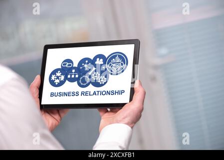 Business relationship concept shown on a tablet held by a man Stock Photo