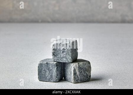 Three stone cubes on a gray concrete pillar. Mockup for presentation and sale of goods Stock Photo