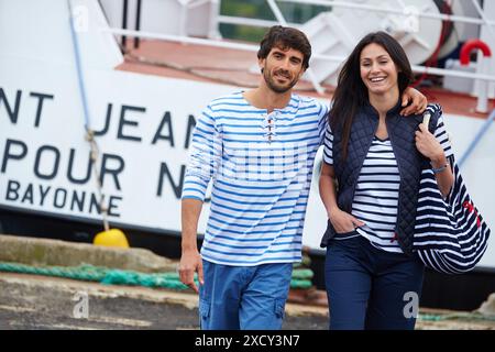 Couple walking. Rain. Marina. Hendaye. Aquitaine. France. Stock Photo