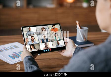 Person Participating In A Video Conference With Multiple Colleagues Stock Photo