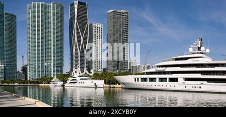 Miami, Florida, USA - 3 December 2023:  The super yacht Infinity moored on the Miami waterfront with two smaller super yachts Stock Photo