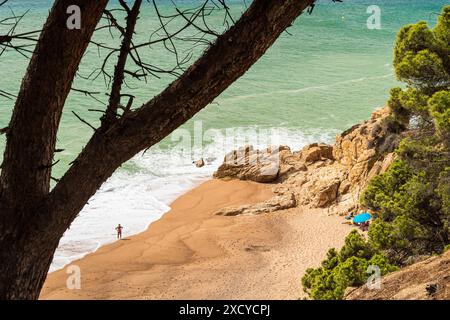 Roca Pins beach in Calella. A picturesque beach between the rocks ...