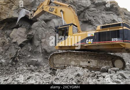 Extracting raw material from quarry for cement manufacturing Stock Photo