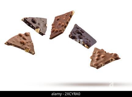 Milk and dark pieces of hazelnut chocolate flying on white background. Stock Photo