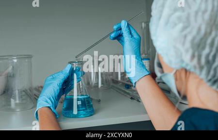scientist meticulously conducts an experiment, symbolizing the relentless pursuit of knowledge and the precision Stock Photo