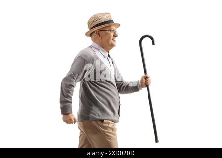 Senior man with walking cane running on white background Stock Photo ...