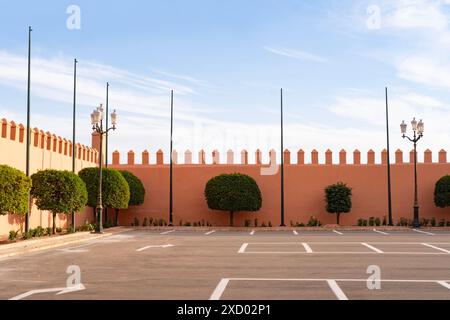 red clay wall in morocco, orange tree in public garden, cultural immersion, agricultural heritage, simple pleasures travel Stock Photo