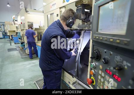 Tuning mooring. Checking with dial indicator. Area automated CNC lathes. Machined Indecober. Machining of precision parts in series. Automotive indust Stock Photo