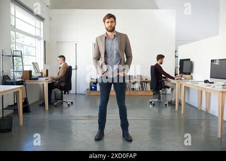 Portrait, businessman and standing in office with confidence, startup and website planning. Web designer, guy and entrepreneur in creative agency for Stock Photo