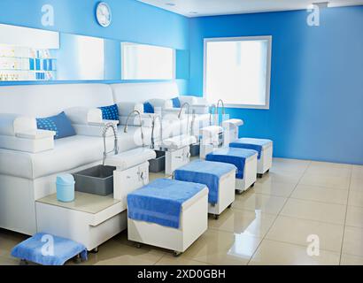 Interior, beauty and clinic with furniture for spa day, massage or therapy on manicure or pedicure. Empty space or room at luxury salon for pamper Stock Photo