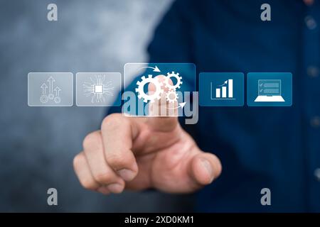 Business process automation concept. Businessman touching Automation software technology on virtual screen to optimise business process workflow. Stock Photo