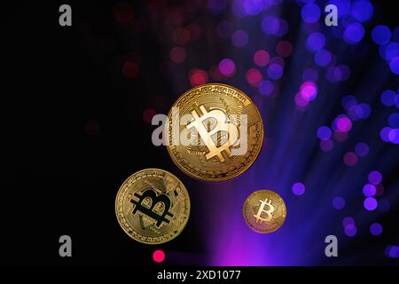Glowing Bitcoin cryptocurrency against the background of fiber optic cables. Bitcoin digital cryptocurrency consisting of dots and lines, cryptocurren Stock Photo