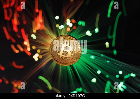 Glowing Bitcoin cryptocurrency against the background of fiber optic cables. Bitcoin digital cryptocurrency consisting of dots and lines, cryptocurren Stock Photo