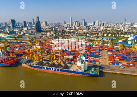 Container ship Jinjiang shipping TS lines in import export business logistics crane harbor, Aerial view International logistics concept. Thailand, Ban Stock Photo
