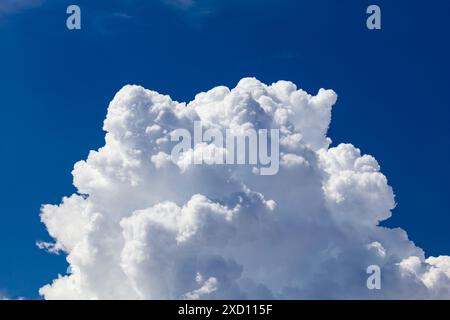 Closeup of Billowy cumulus clouds. Wispy clouds, deep blue sky in background. Stock Photo