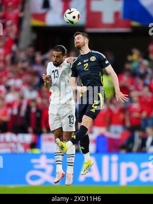 Scotland's Anthony Ralston (right) and Switzerland's Ricardo Rodriguez battle for a header during the UEFA Euro 2024 Group A match at the Cologne Stadium in Cologne, Germany. Picture date: Wednesday June 19, 2024. Stock Photo