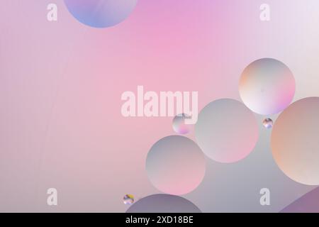 Circles in varying sizes on a pink and purple gradient background, creating an abstract, dreamy, and colorful pattern Stock Photo
