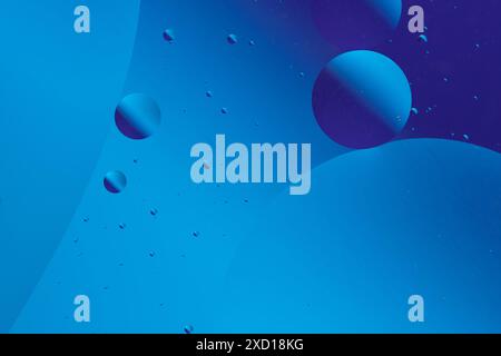 Calm and minimalistic abstract design with blue and purple bubbles different sizes on dark blue background Stock Photo