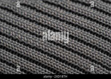 Texture of knitted fabric in closeup. Grey background Stock Photo