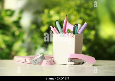 Stapler, holder and other different stationery on white table Stock Photo