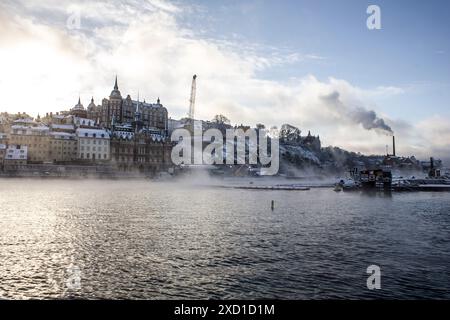 A landscape shot of a cold winter afternoon in stockholm, fog rises from the waters. Stock Photo