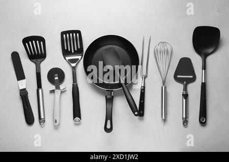 Different spatulas and other kitchen utensils on grey background, flat lay Stock Photo
